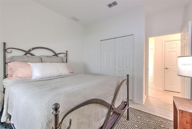 bedroom with hardwood / wood-style flooring and a closet