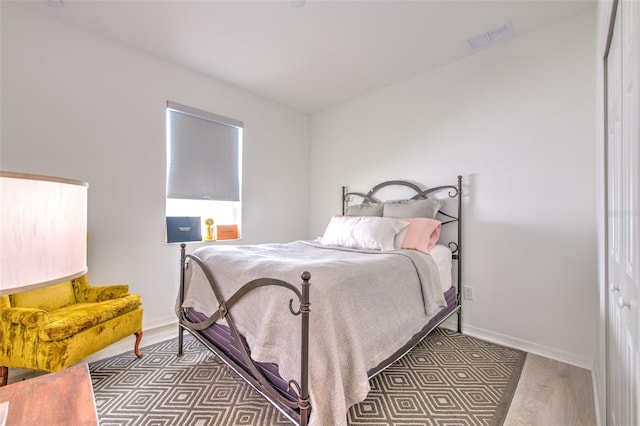 bedroom with hardwood / wood-style floors