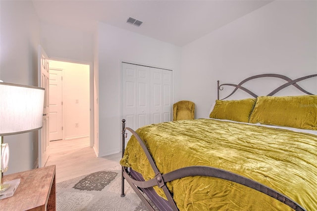 bedroom featuring light hardwood / wood-style floors and a closet