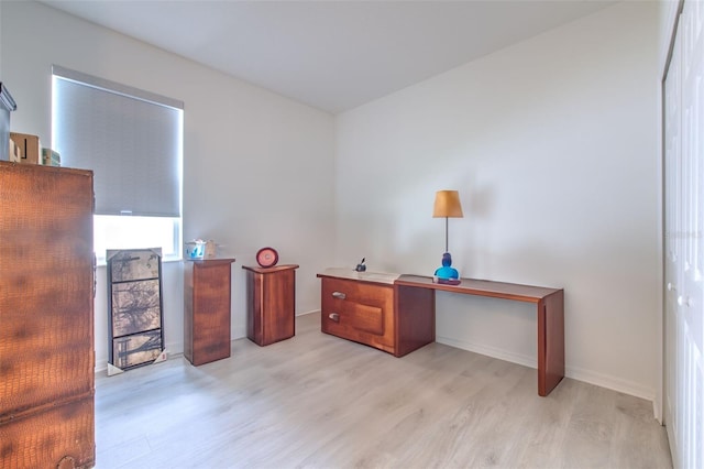 office area with light hardwood / wood-style floors