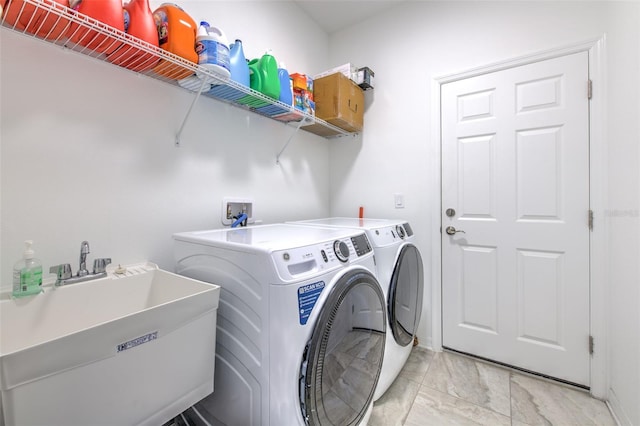 washroom featuring washing machine and dryer and sink