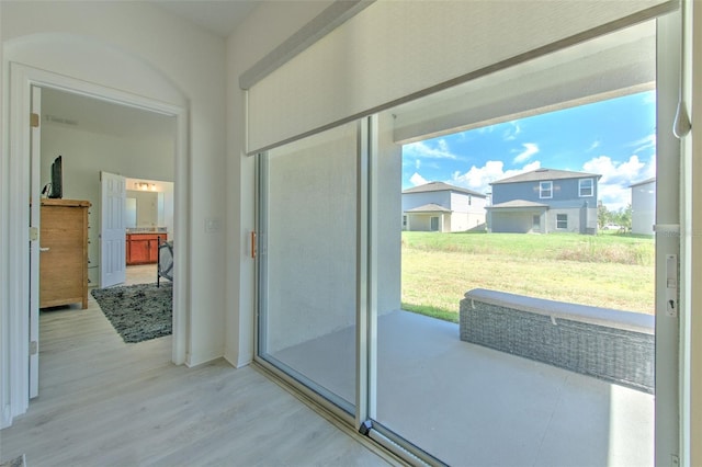 doorway to outside with light wood-type flooring