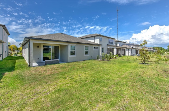 rear view of property with a yard