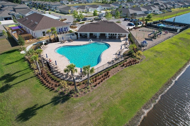 view of swimming pool featuring a patio and a water view