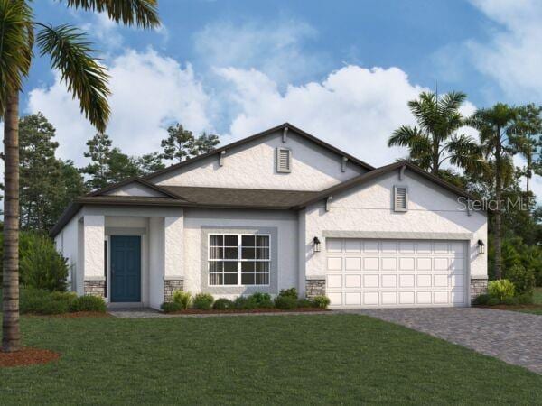 view of front of property with a garage and a front yard