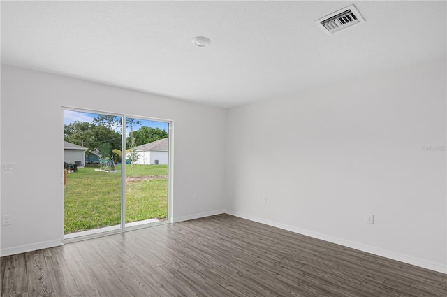 empty room with dark wood-type flooring