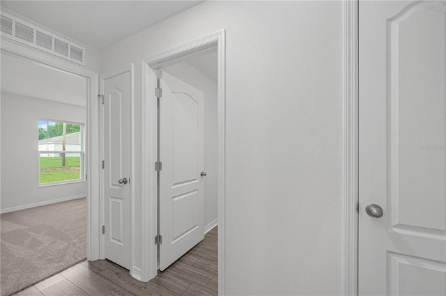 corridor with light hardwood / wood-style flooring