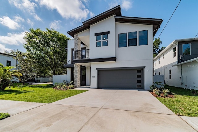 contemporary home featuring a garage, concrete driveway, stucco siding, fence, and a front yard