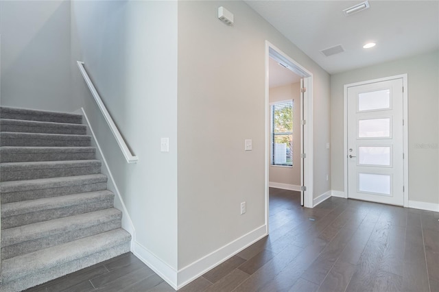 foyer entrance featuring visible vents, baseboards, dark wood-style floors, stairway, and recessed lighting