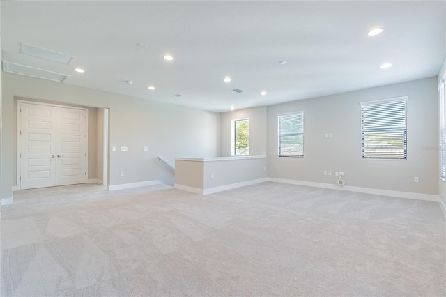 unfurnished room featuring light carpet, baseboards, and recessed lighting