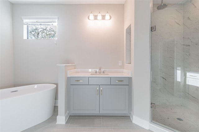 full bath featuring a stall shower, baseboards, tile patterned floors, a freestanding bath, and vanity