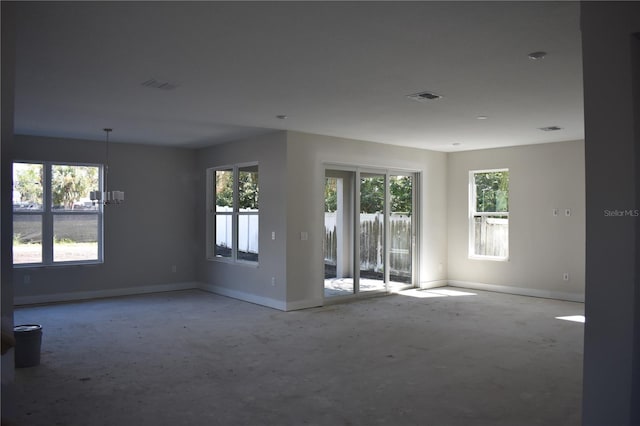 spare room with baseboards and visible vents