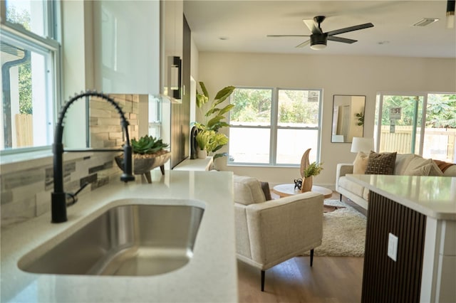 interior space featuring hardwood / wood-style flooring, sink, and ceiling fan