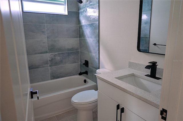 full bathroom featuring tiled shower / bath combo, vanity, toilet, and tile patterned flooring