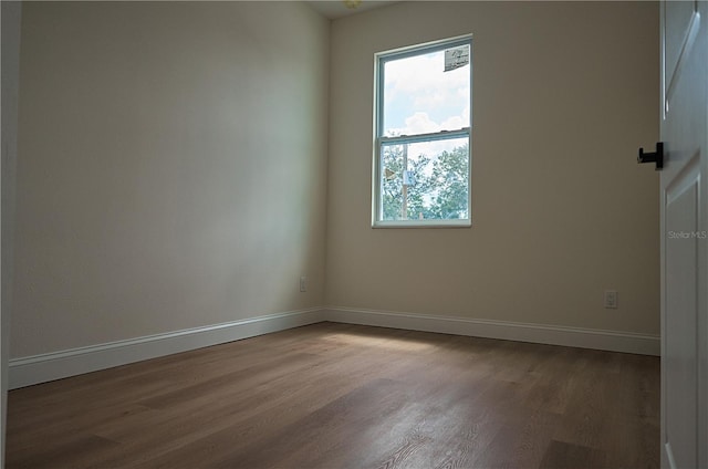 spare room with hardwood / wood-style flooring