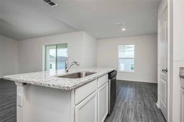 kitchen with dishwasher, sink, white cabinets, dark wood-type flooring, and a kitchen island with sink