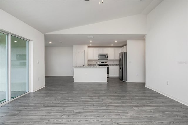 kitchen featuring white cabinetry, stainless steel appliances, lofted ceiling, and a wealth of natural light