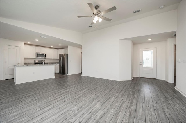 unfurnished living room featuring light hardwood / wood-style floors and ceiling fan