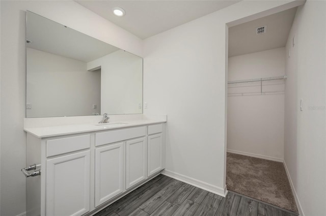 bathroom with vanity and wood-type flooring