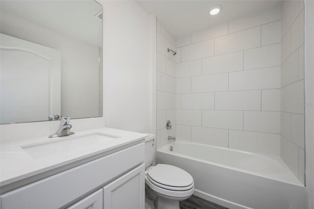 full bathroom with vanity, toilet, and tiled shower / bath combo