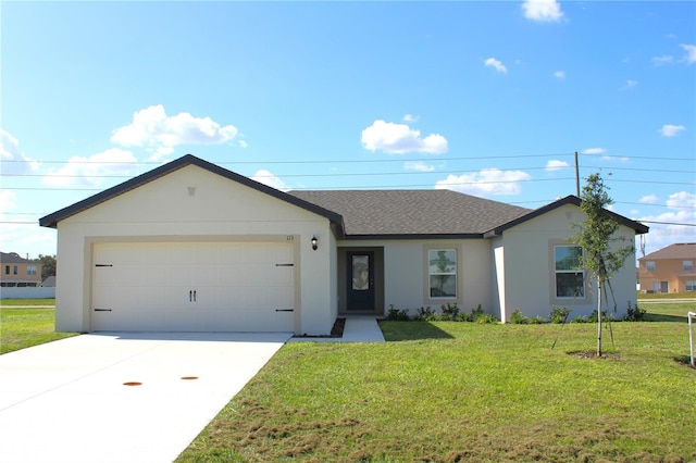 ranch-style house featuring a front lawn and a garage