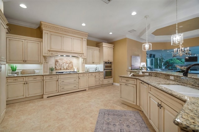 kitchen featuring sink, crown molding, hanging light fixtures, stainless steel appliances, and cream cabinetry