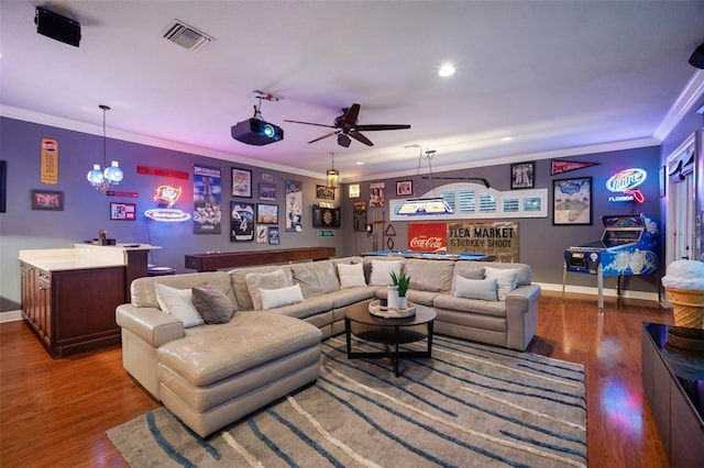 living room featuring crown molding, indoor bar, dark hardwood / wood-style floors, and ceiling fan