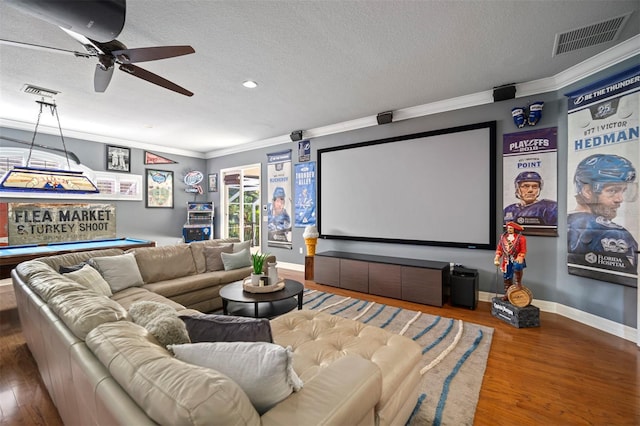 home theater featuring pool table, a textured ceiling, ornamental molding, ceiling fan, and hardwood / wood-style floors