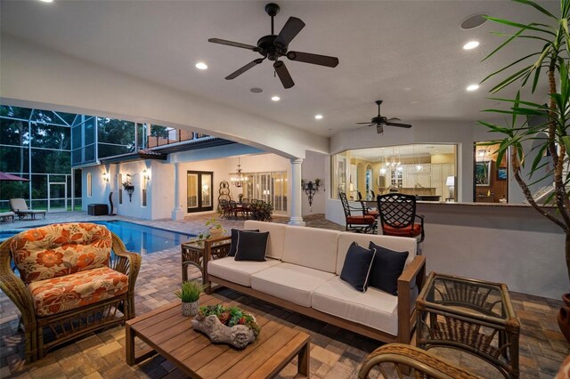 interior space featuring decorative columns and ceiling fan with notable chandelier