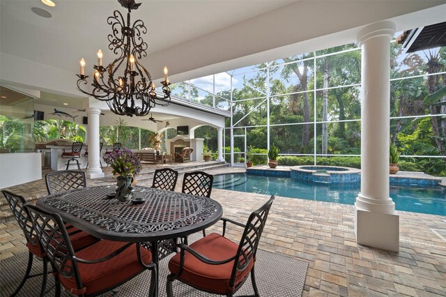 view of swimming pool with a patio, a lanai, an in ground hot tub, and an outdoor bar