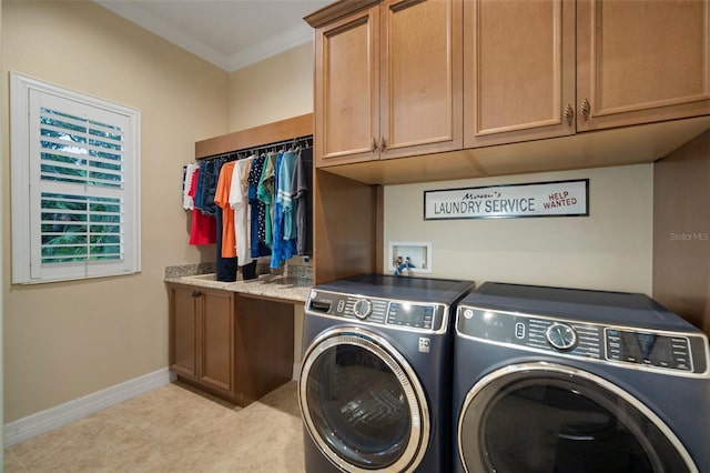 laundry area featuring crown molding, independent washer and dryer, light tile flooring, washer hookup, and cabinets