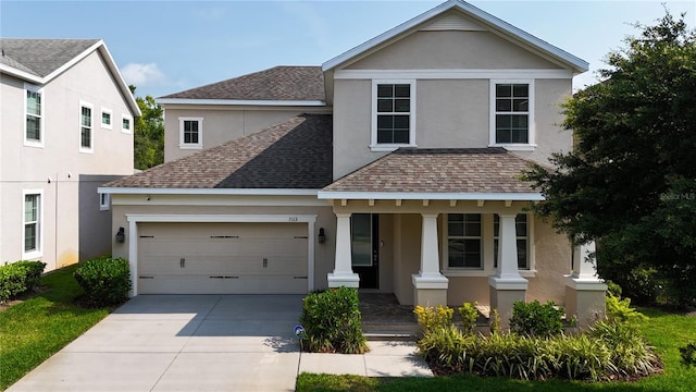 front facade featuring covered porch and a garage