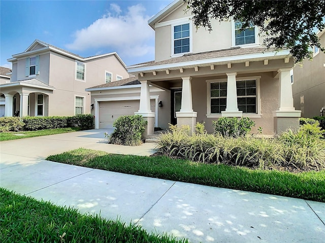 view of front of property with a porch and a garage