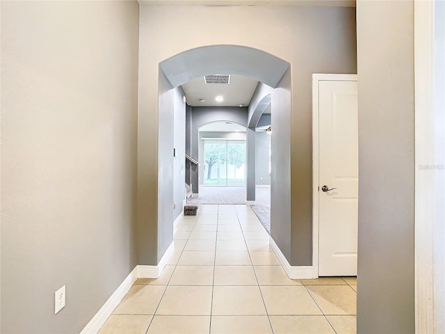 hall with light tile patterned floors