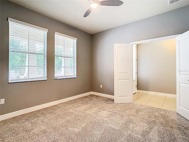 unfurnished bedroom with light colored carpet and ceiling fan