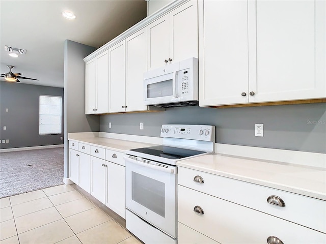 kitchen featuring white cabinets, light carpet, white appliances, and ceiling fan