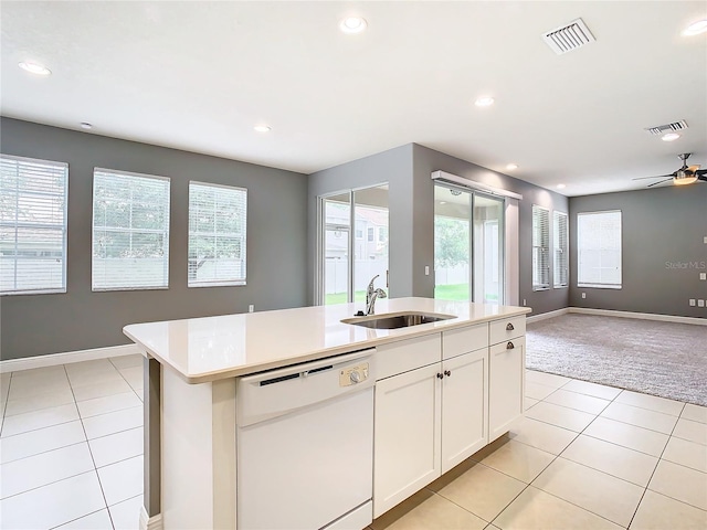 kitchen with white cabinetry, sink, ceiling fan, white dishwasher, and a kitchen island with sink