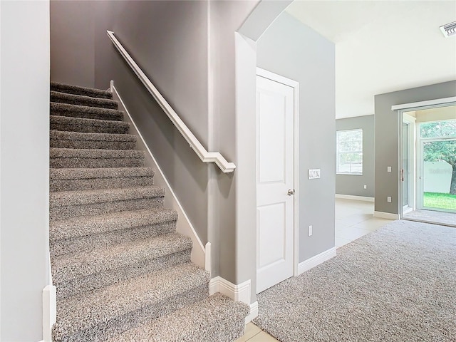 stairway featuring tile patterned floors