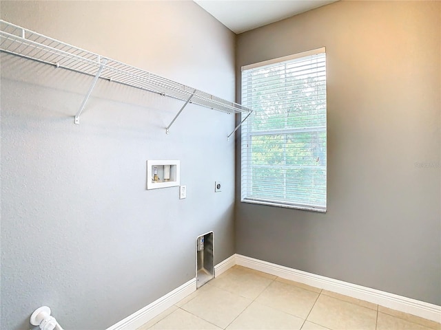 clothes washing area featuring hookup for a washing machine, light tile patterned floors, and hookup for an electric dryer