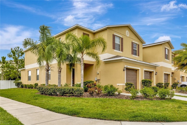 view of front of home with a garage and a front yard