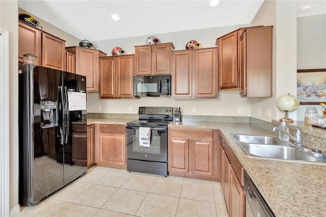 kitchen with light tile patterned floors, sink, and black appliances