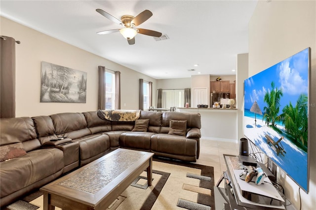 tiled living room with ceiling fan