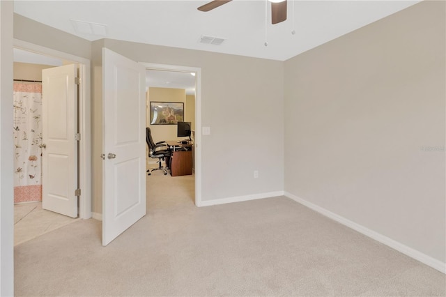 carpeted empty room featuring ceiling fan