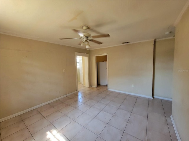 spare room featuring light tile patterned floors, baseboards, visible vents, and a ceiling fan