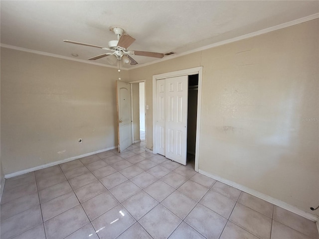 unfurnished bedroom featuring ornamental molding, a closet, a ceiling fan, and baseboards