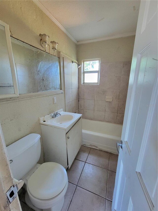 bathroom with bathtub / shower combination, toilet, ornamental molding, vanity, and tile patterned flooring