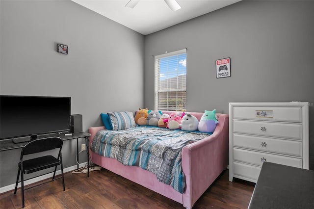 bedroom with a ceiling fan, baseboards, and wood finished floors