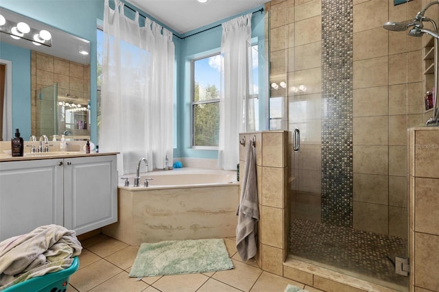 bathroom with tile patterned flooring, vanity, a bath, and a shower stall