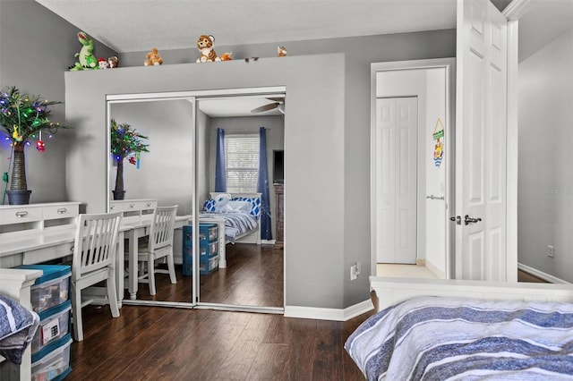 bedroom with wood finished floors and baseboards