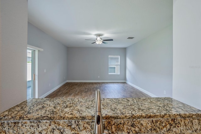 interior space featuring hardwood / wood-style floors and ceiling fan